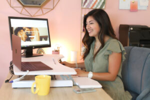 Priscilla Rodriguez sitting at her desk working as an Anxiety Therapist in San Antonio, TX.