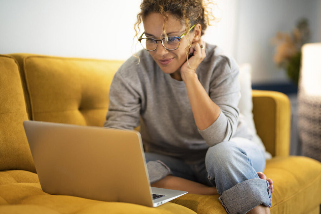 Young woman working with an Anxiety Therapist on her laptop in order to overcome her anxiety. Online Therapy for Anxiety in San Antonio is available, easy, and effective.