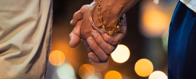 Couple walking at night with their hands clasped representing the deepened connection that can be formed with the help of Couples Counseling in San Antonio, TX.