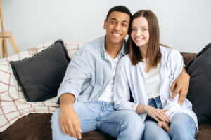 Reconnecting as a couple, sitting together on couch deciding to get the help of Couples Counseling in San Antonio, Texas. 78249, 78229, 78256, 78257, 78759, 78727, 77005, 75225