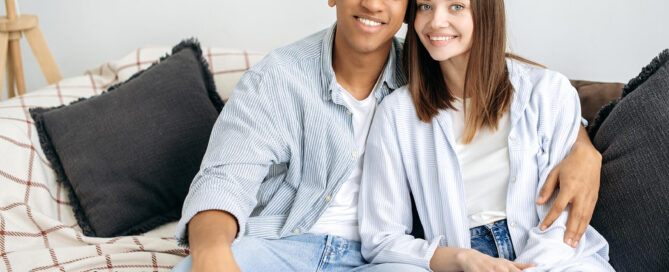 Couple sitting together on couch deciding to get the help of Couples Counseling in San Antonio, Texas. 78249, 78229, 78256, 78257, 78759, 78727, 77005, 75225