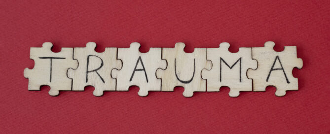 Wooden tiles spelling out Trauma on a red background. Trauma does not have to control your life. Therapy for Trauma in San Antonio, TX can help you find peace.