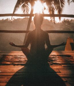 Woman enjoying yoga in a quiet and calm environment at the beach during sunset. San Antonio, Tx. Modern Wellness Counseling. 78249, 78255, 78258, 78259, 78216, 78230.
