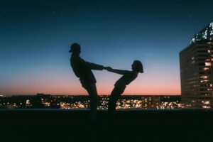 Couple doing silly poses, trust fall, in the sunset, San Antonio, Tx. Modern Wellness Counseling. 78255,78258,78256,78249,78246.