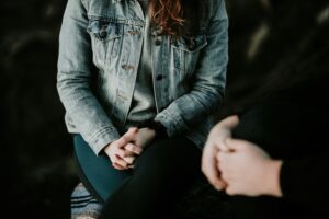 Couple having a serious conversation, hands both tense. By forgiving, you free yourself from the shackles of bitterness and resentment, allowing for personal growth and emotional well-being. San Antonio, Tx. Modern Wellness Counseling, virtual counseling. 78240,78230,78255,78258,78249,78260