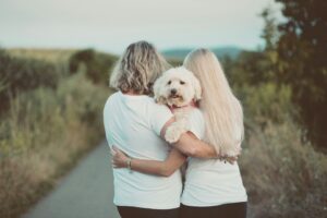 Family holding each other close and not letting go, holding their dog close to them. intimate moment. Modern Wellness Counseling, San Antonio, Tx. 78230,78245,78249,78255,78258.