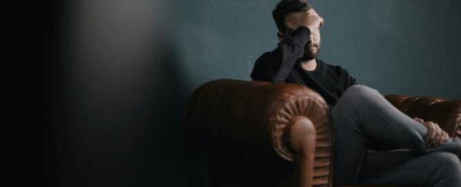 Man sitting on couch with mental overload in San Antonio, Texas. 78249, 78229, 78256, 78257, 78759, 78727, 77005, 75225