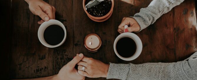 Couple holding hands in coffee shop building physical intimacy in San Antonio, Texas. 78249, 78229, 78256, 78257, 78759, 78727, 77005, 75225
